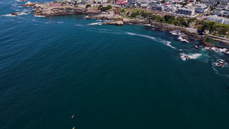 Drone-pullback-over-kayakers-in-Walker-Bay---scenic-coastal-town-Hermanus