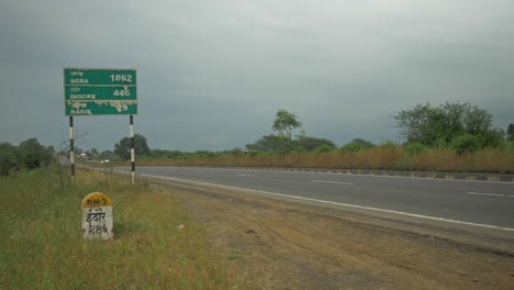 A-green-sign-board-shows-distance-of-major-cities-on-National-Highway-near-Nashik