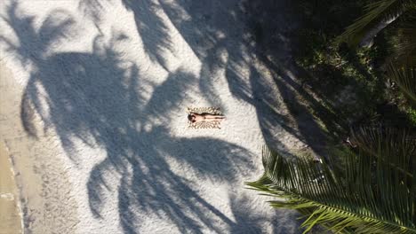 Beautiful-Girl-Suntanning-Topless-on-warm-Brazilian-Beach-Drone-shot-Panning-Up