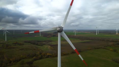 Aerial-shot-of-multiple-rotating-windmills-for-renewable-electric-power-production-in-a-wide-rural-area