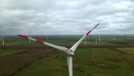 Aerial-shot-of-multiple-windmills-for-renewable-electric-power-production-in-a-wide-rural-area