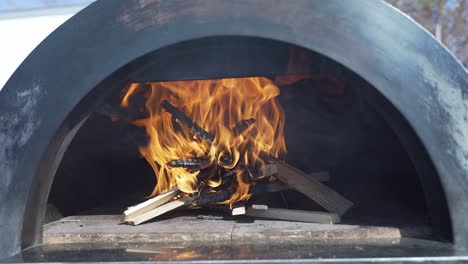 Wood-burning-in-smokey-wood-fire-pizza-oven-outdoors