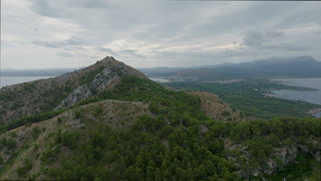 Drone-flight-on-the-coast-of-Mallorca-overlooking-the-area-of-Bahia-de-Pollenca-with-spectacular-view-over-the-mountains
