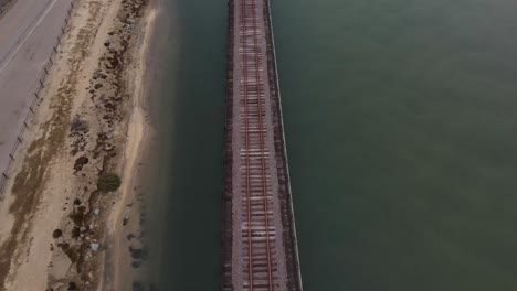 slow-tilt-up-over-railroad-track-in-lagoon