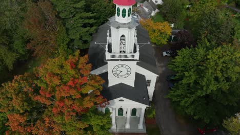 Rising-aerial-of-white-church-building-with-steeple-and-belfry-in-small-town-America