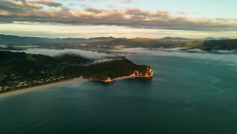 Motion-lapse-of-cloud-inversion-rolling-over-scenic-lookout-in-the-Coromandel-Peninsula,-New-Zealand