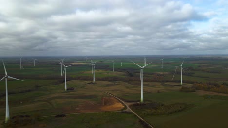 Aerial-shot-of-group-rotating-windmills-in-wind-farm-for-renewable-electric-power-production-in-a-countryside