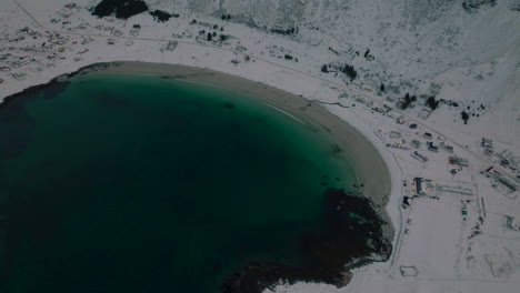 Dark-Lofoten-islands-ocean-aerial-reveal-view-to-Ramberg-extreme-glacial-mountain-range