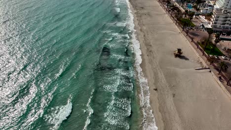 Fly-over-beach-with-waves