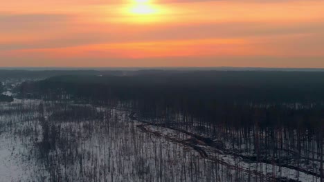 Overview-Shot-Of-Wide-Snowy-Swamp-At-Sunset-Time,-Colorful-Sky,-USA