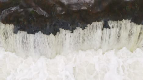 Salmon-spawning-in-Venta-Rapid-waterfall,-aerial-closeup-view