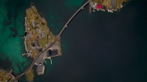 Winding-Lofoten-bridge-crossing-Reine-archipelago-fishing-villages-and-arctic-ocean-aerial-view-top-down