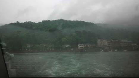 View-from-the-ferry-at-Miyajima-shore-on-misty-morning,-Japan
