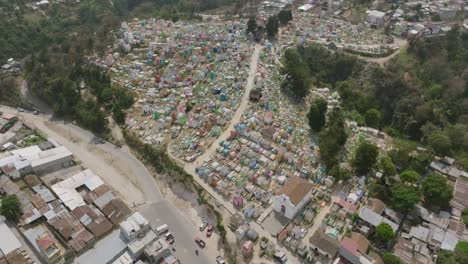 Wide-aerial-footage-that-pans-up-revealing-the-large-cemetery-that-is-in-Chichicastenango,-Guatemala