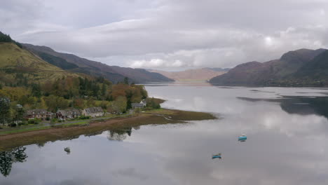 An-aerial-view-looking-west-down-Loch-Duich-in-the-Northwest-Highlands-of-Scotland-in-Glen-Shiel-on-a-cloudy-day