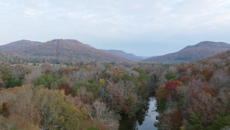 Aerial-footage-in-Sequatchie-Cove,-Tennessee-during-autumn-with-winter-trees-following-a-river
