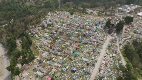 Aerial-footage-moving-from-left-to-right-over-a-colorful-cemetery-in-the-city-of-Chichicastenango-in-northern-Guatemala