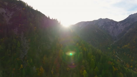 Sunlight-shining-across-Tyrol-woodland-mountains-aerial-view-across-Karwendel-district-landscape