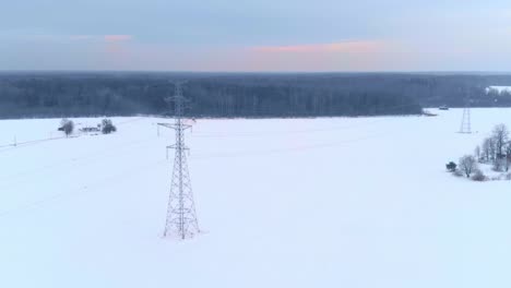 Power-line-pillars-in-winter---energy-crisis,-aerial-view