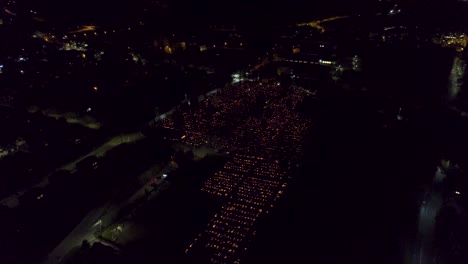 Aerial-view-of-huge-graveyard-illuminated-by-candles