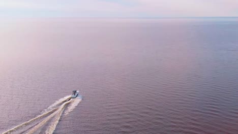 Tracking-Shot-Of-Small-Boat-Speeding-In-Baltic-Sea,-Eastern-Europe