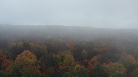 Fast-reversing-aerial-shot-of-foggy-foliage-in-Pennsylvania