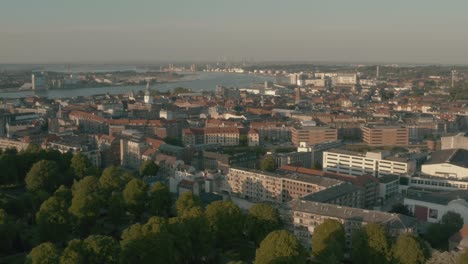 Flying-in-circle-around-the-city-of-Aalborg,-with-drone