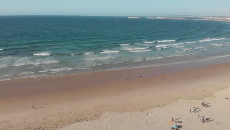 Aerial-view-of-the-beach-with-surfers-in-west-coast-of-Portugal-in-Baleal,-Peniche