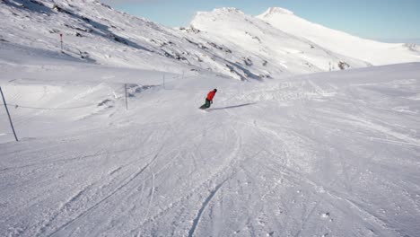 Snowboarder-making-turns-wide-slow-motion-shot