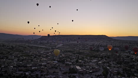 Göreme-Turkey-Aerial-v46-breathtaking-landscape-view-flyover-village-town-capturing-mesa-flat-tableland-mountain-against-cappadocian-horizon-at-dawn-before-sunrise---Shot-with-Mavic-3-Cine---July-2022