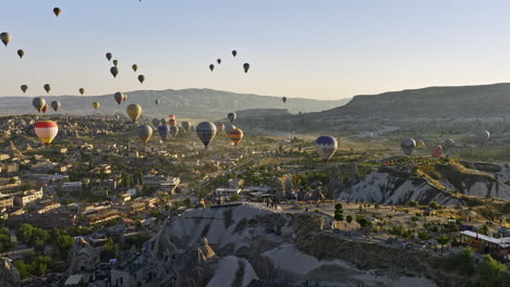 Göreme-Turkey-Aerial-v69-low-level-drone-fly-around-plateau-view-point-capturing-panoramic-cappadocia-landscape-with-colorful-hot-air-balloons-flying-in-the-sky---Shot-with-Mavic-3-Cine---July-2022