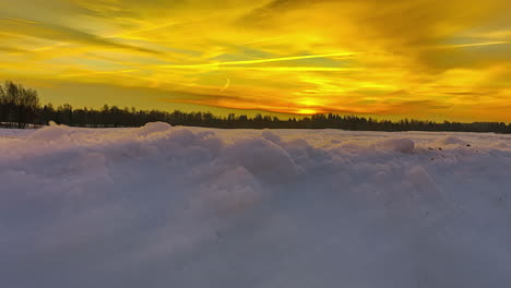 Winter-Landscape-Revealed-Behind-Fresh-White-Snow-Under-Golden-Sky-At-Sunrise