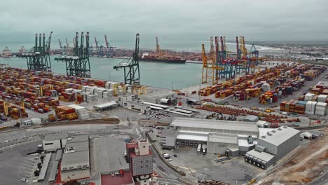 Drone-of-cargo-commercial-dock,-industrial-port-with-containers-and-big-cranes