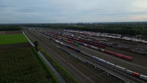 Aerial-View-Of-Kijfhoek-Hump-Yard-With-Wagon-Train-Going-Past-Parked-Wagon-Trains