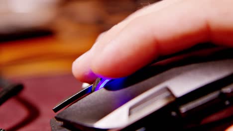 Close-up-of-gamer-mouse-with-rainbow-LED-lights,-clicking-and-scrolling