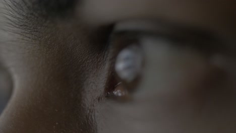 Super-extreme-close-up-of-a-female-human-eye-reflecting-a-desktop-screen-while-doom-scrolling-or-doom-surfing-on-the-web-putting-unhealthy-strain-on-the-eyes