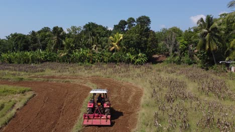 Tractor-plowing-rice-paddy-fields-of-Polonnaruwa-in-Sri-Lanka