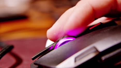 Close-up-of-gamer-mouse-with-rainbow-LED-lights,-clicking,-scrolling-up-and-moving-around