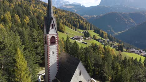 Beautiful-Aerial-View-of-Saint-Jakob's-Church-in-Val-Gardena,-Dolomites