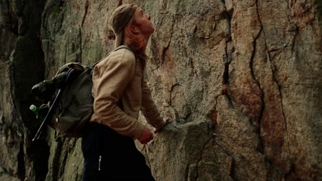 Hiker-With-Backpack-Standing-Next-Huge-Rock-Looking-Up,-Vogelberg,-Dürnstein