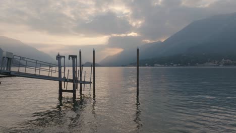 4K-Aerial---Sunset-shot-pushing-through-morring-poles-low-and-slow-over-the-lake-in-Bellagio,-Lake-Como,-Italy