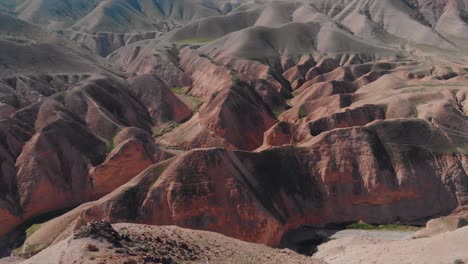Amazing-flying-Drone-shot-of-a-desert-green-mounts,-Jurassic-park-look