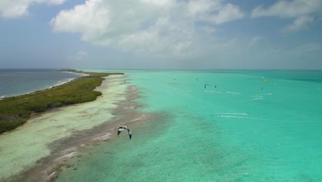 Adventure-sports-in-nature-landscape,-group-people-KITEsurf,-drone-shote-SALINAS-LOS-ROQUES