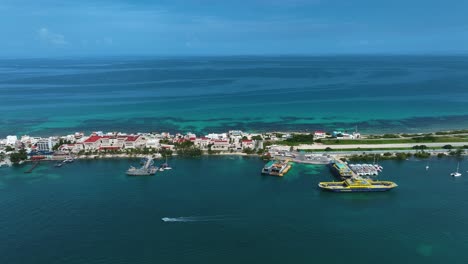 Aerial-view-overlooking-the-marina-of-Isla-Mujeres,-in-sunny-Mexico---tracking,-drone-shot