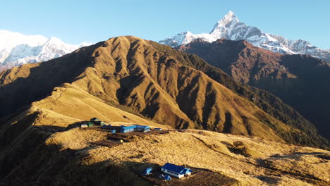 Aerial-shot-reveals-Mt-Fishtail,-Annapurna-Range-and-Dhaulagiri-from-the-top-of-Khumai-Dada-in-Nepal