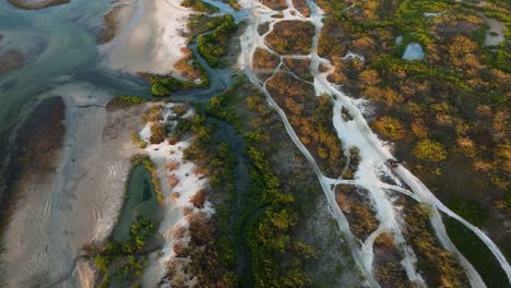 Drone-view-of-buggy-tour-through-coastal-dunes-and-lagoons,-Jericoacoara,-Cear?