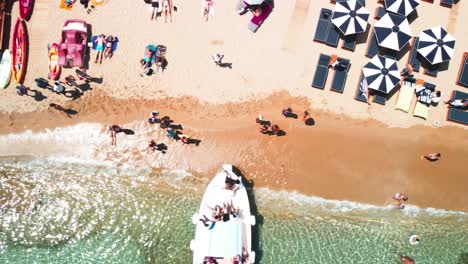 Top-Down-drone-shot-above-the-beach-with-people-on-the-sand-during-a-sunny-summer-day-at-Mykonos-Greece---Paradise-Super-Beach