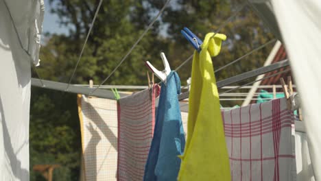 Clothing-Hung-On-Clothesline-Outdoor-Secured-With-Clothespins
