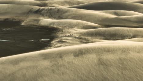 Aerial-panning-shot-of-beautiful-sandy-desert-dunes-during-desertification-in-Northeastern,-Brazil