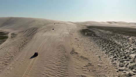 Buggy-tour-in-landscape-with-vast-sand-dunes---aerial-tracking-shot